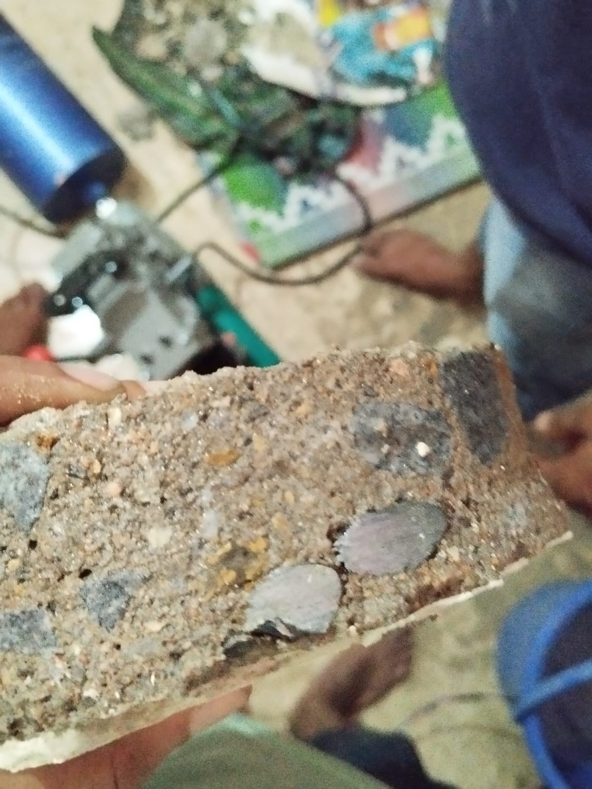 Concrete core cross section showing dense aggregate and cut rebar Kanpur
